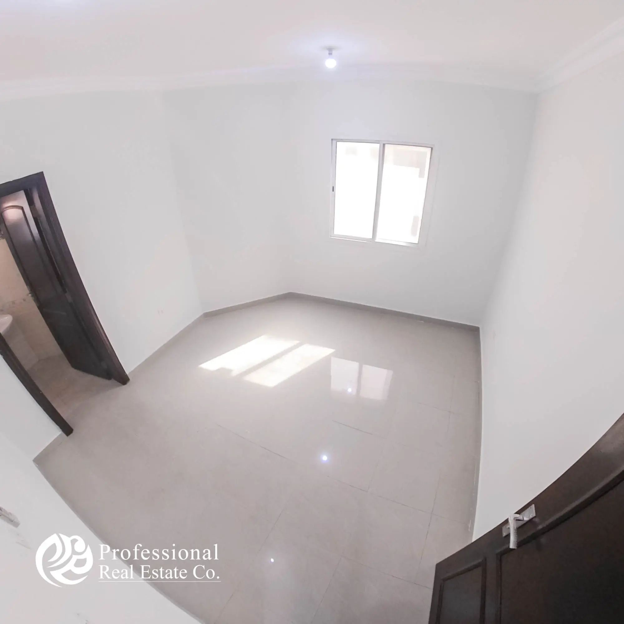 Cozy bedroom with tiled flooring and window in unfurnished 1 BHK apartment in Umm Ghuwailina, Doha
