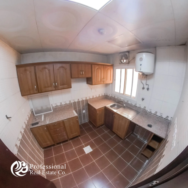 Alternative view of closed kitchen with cabinets and countertop in 1 BHK apartment in Umm Ghuwailina, Doha