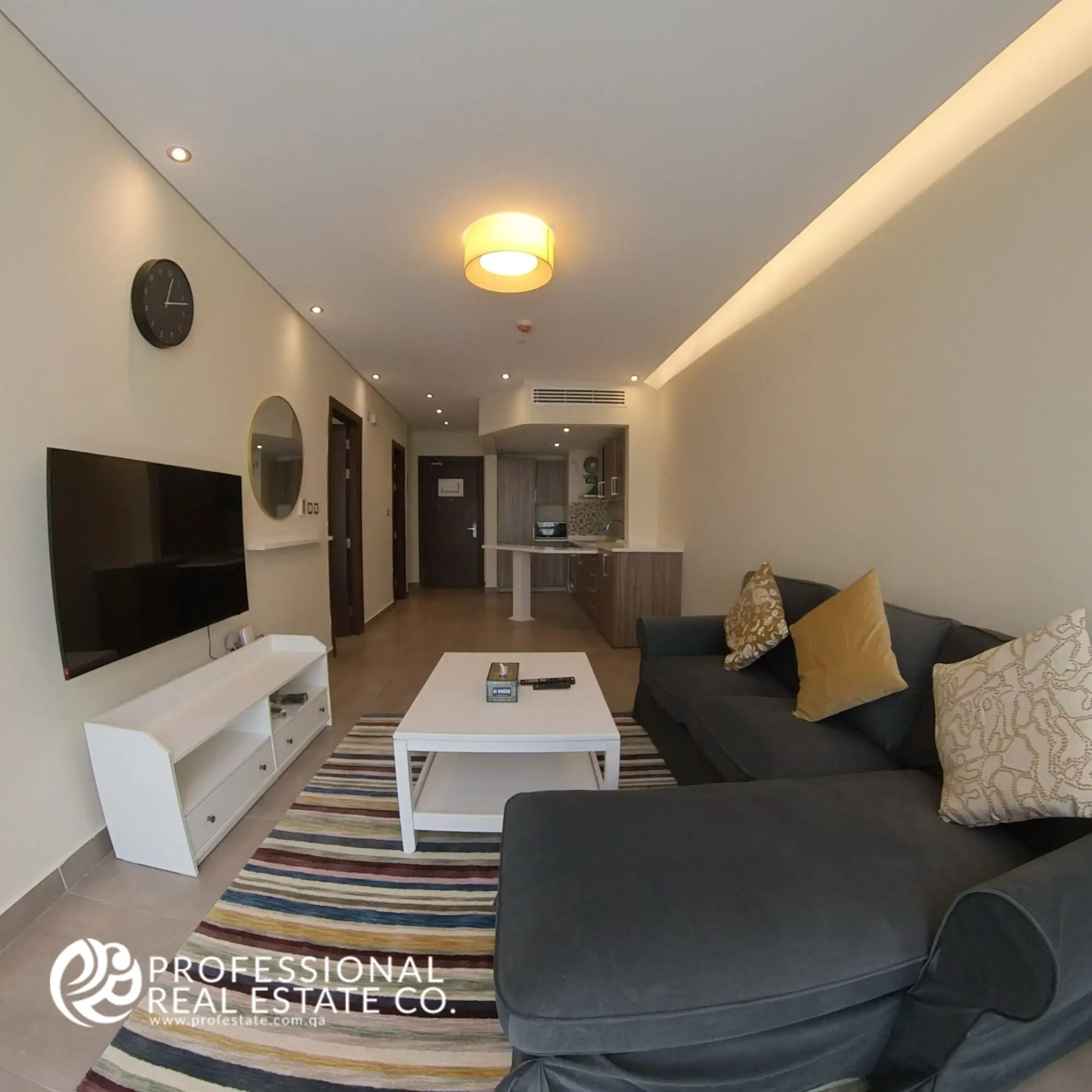 Closer look at the living room in a fully furnished 1 BHK apartment in Al Sadd, showcasing modern furniture, intricate decor, and cozy ambiance.