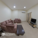 Living room with modern furnishings and natural light in a fully furnished 2 BHK apartment in Bin Mahmoud, Doha