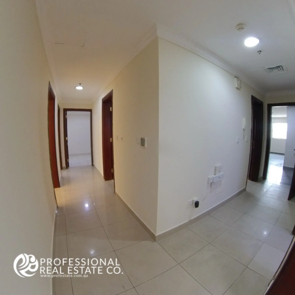 Hallway with tiled flooring and neutral walls in an unfurnished 3 BHK apartment in Bin Mahmoud, Doha