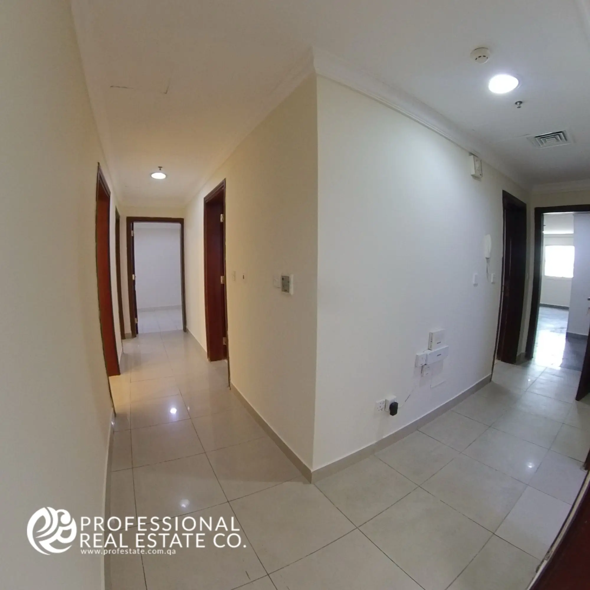 Hallway with tiled flooring and neutral walls in an unfurnished 3 BHK apartment in Bin Mahmoud, Doha