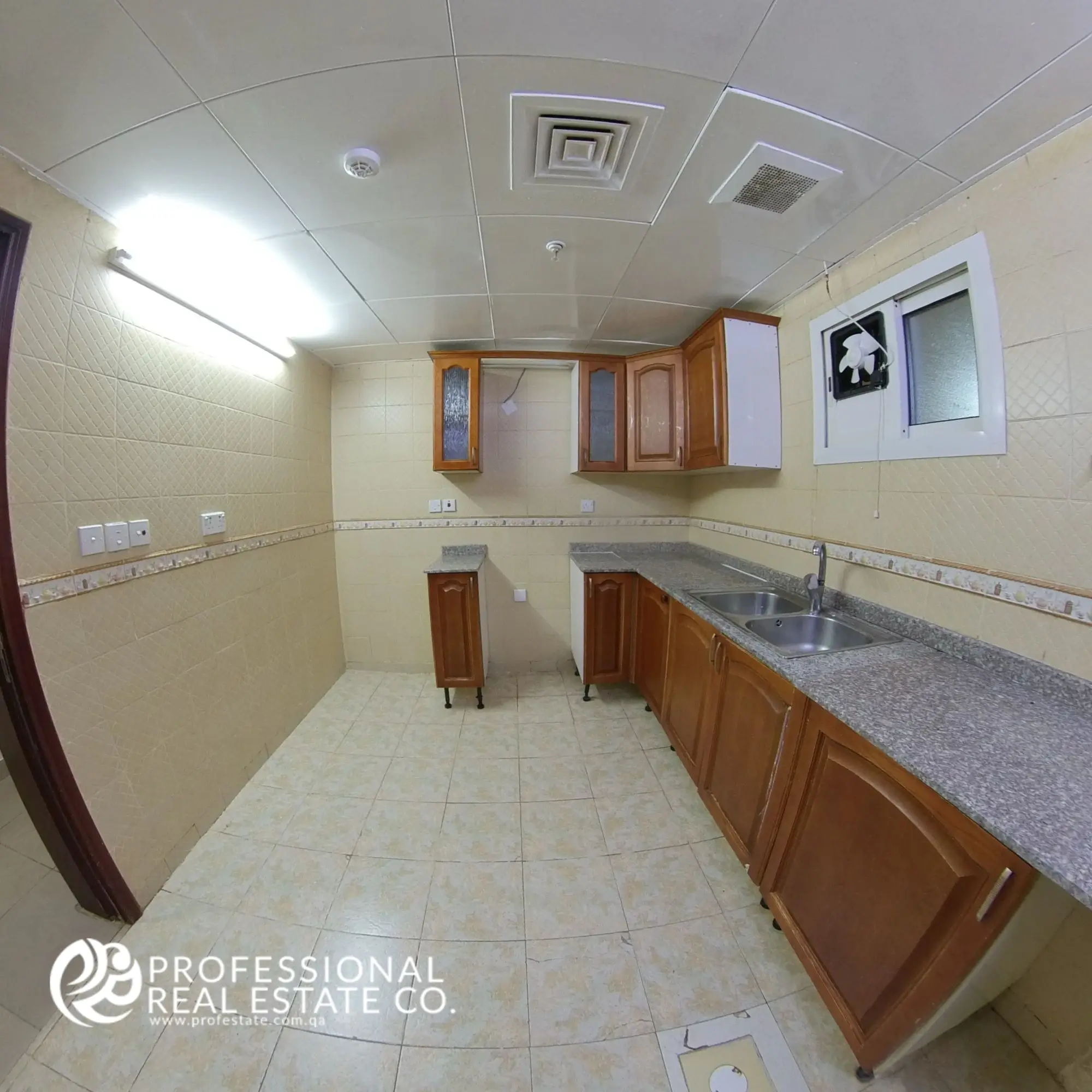 Alternative view of closed kitchen with cabinetry and countertop in an unfurnished 3 BHK apartment in Bin Mahmoud, Doha