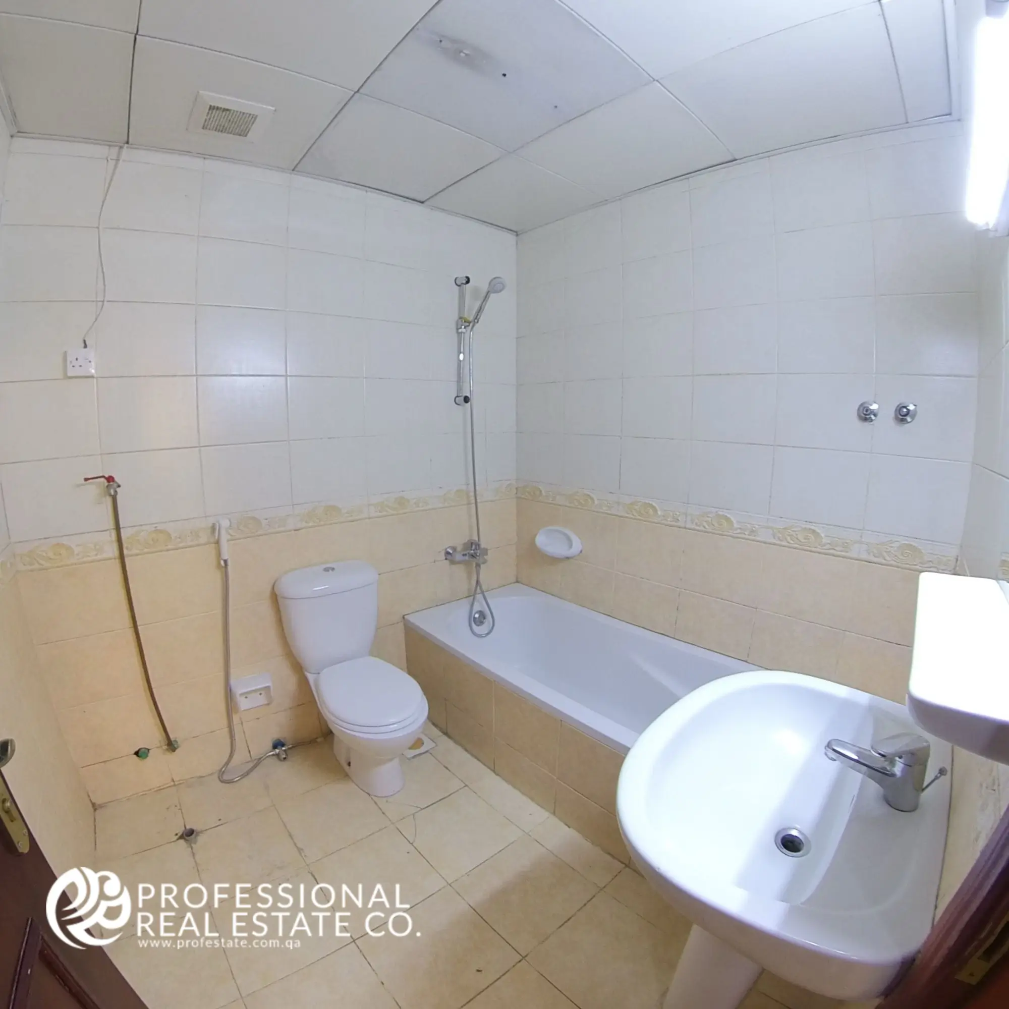 Toilet room with bathtub and shower in an unfurnished 3 BHK apartment in Bin Mahmoud, Doha