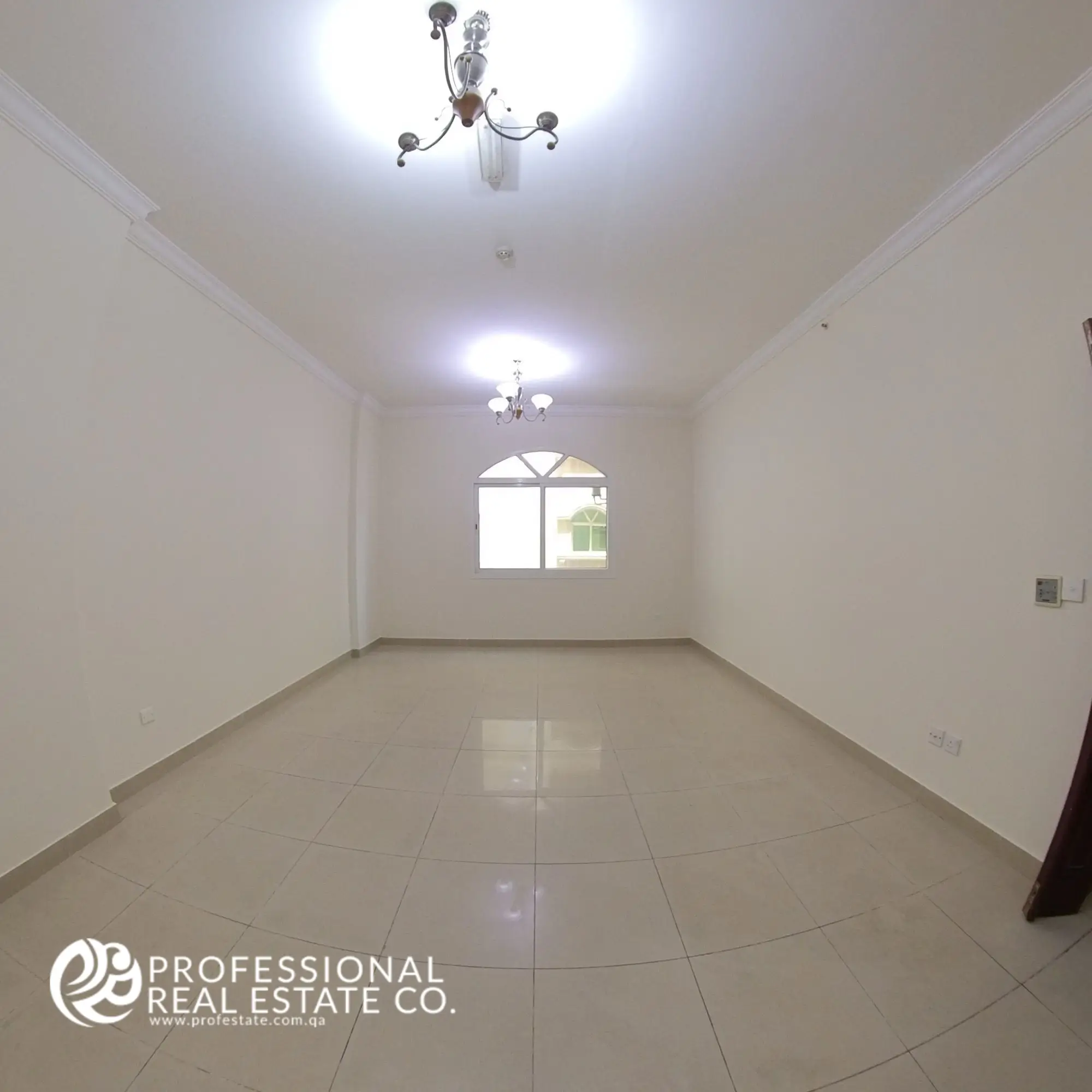Living room with tiled flooring and natural light in an unfurnished 3 BHK apartment in Bin Mahmoud, Doha