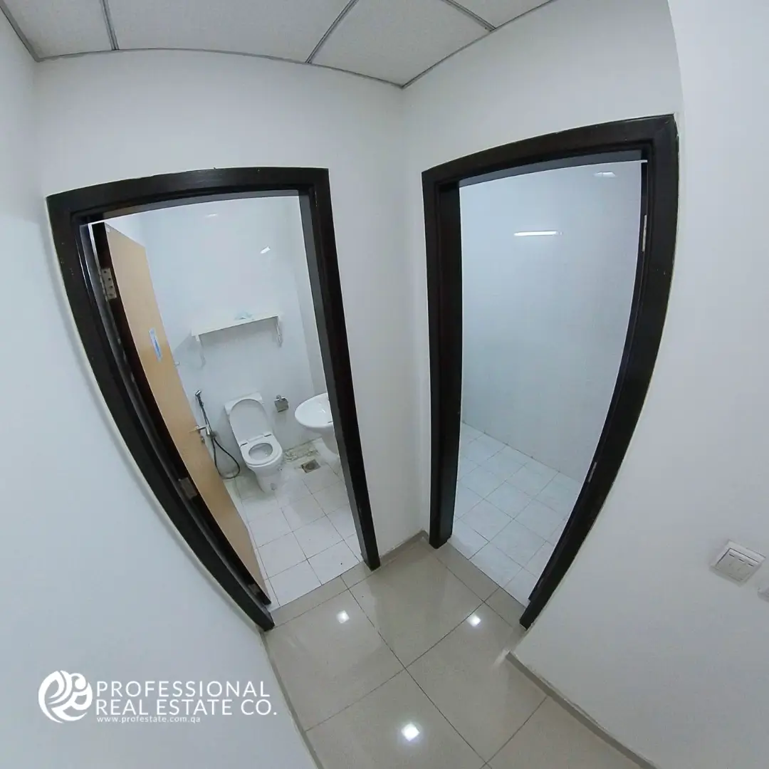 Entrance of toilet rooms in unfurnished office open space in Bin Mahmoud, Doha