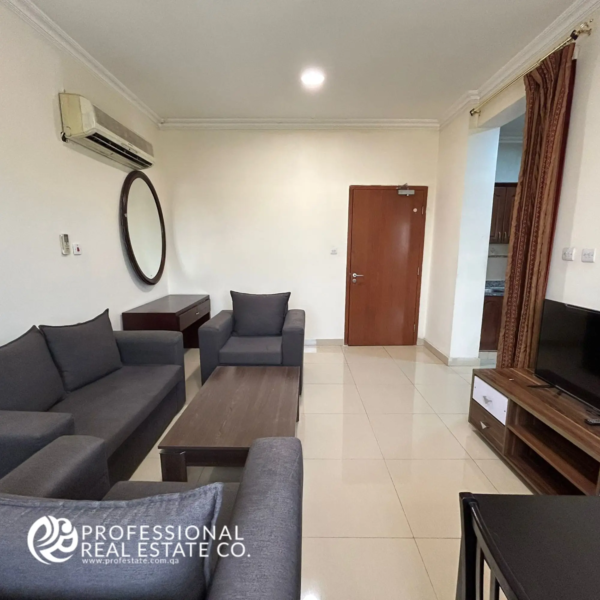 Closer view of the living area in a fully furnished 1 BHK apartment in Umm Ghwailina, featuring a cozy sofa setup and elegant interior details.