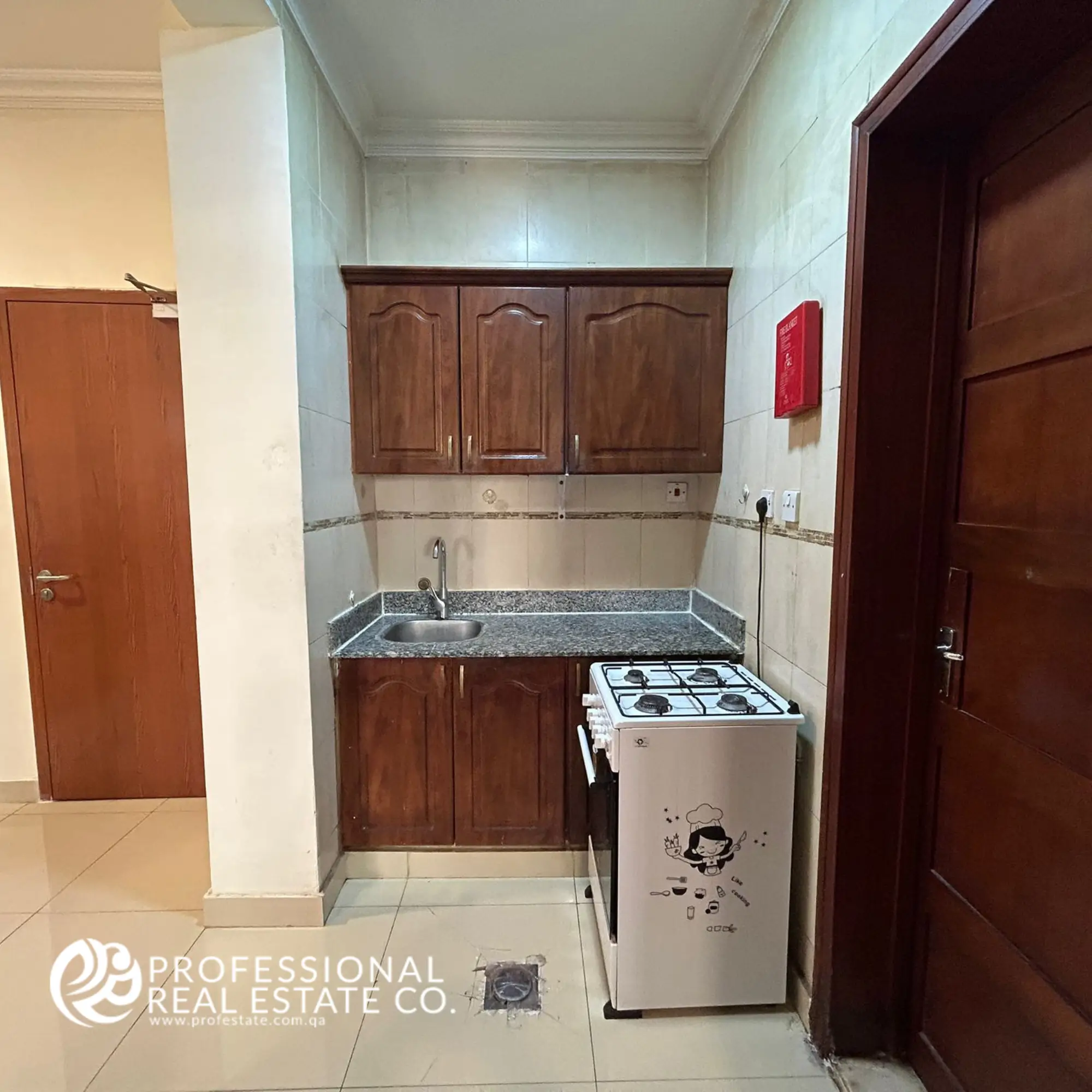 Open kitchen in a fully furnished 1 BHK apartment in Umm Ghwailina, featuring a modern layout with stylish countertops and functional design.