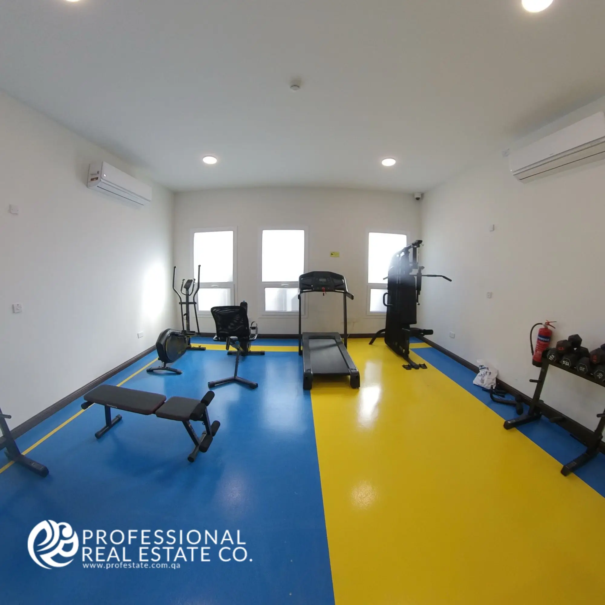 Gym with basic fitness equipment in a fully furnished 2 BHK apartment in Al Waab, Doha