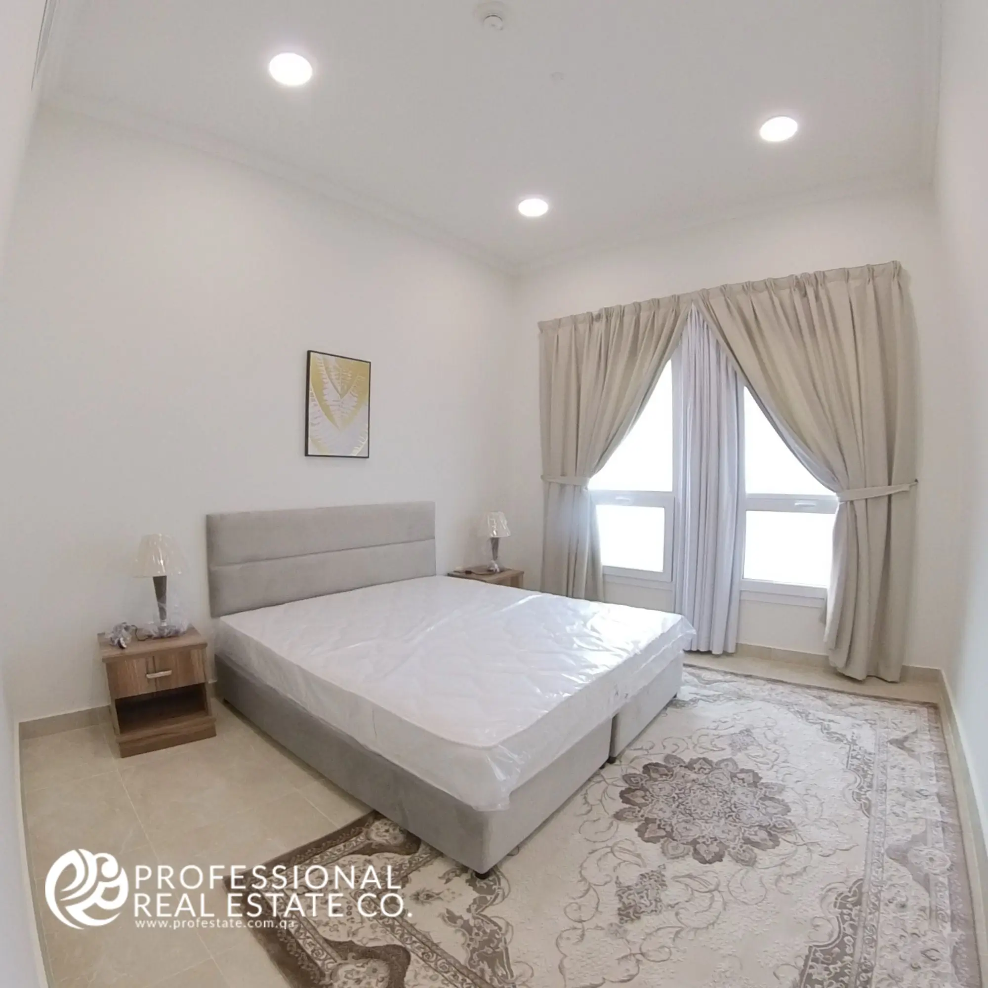 Bedroom 1 with large window and modern furnishings in a fully furnished 2 BHK apartment in Al Waab, Doha
