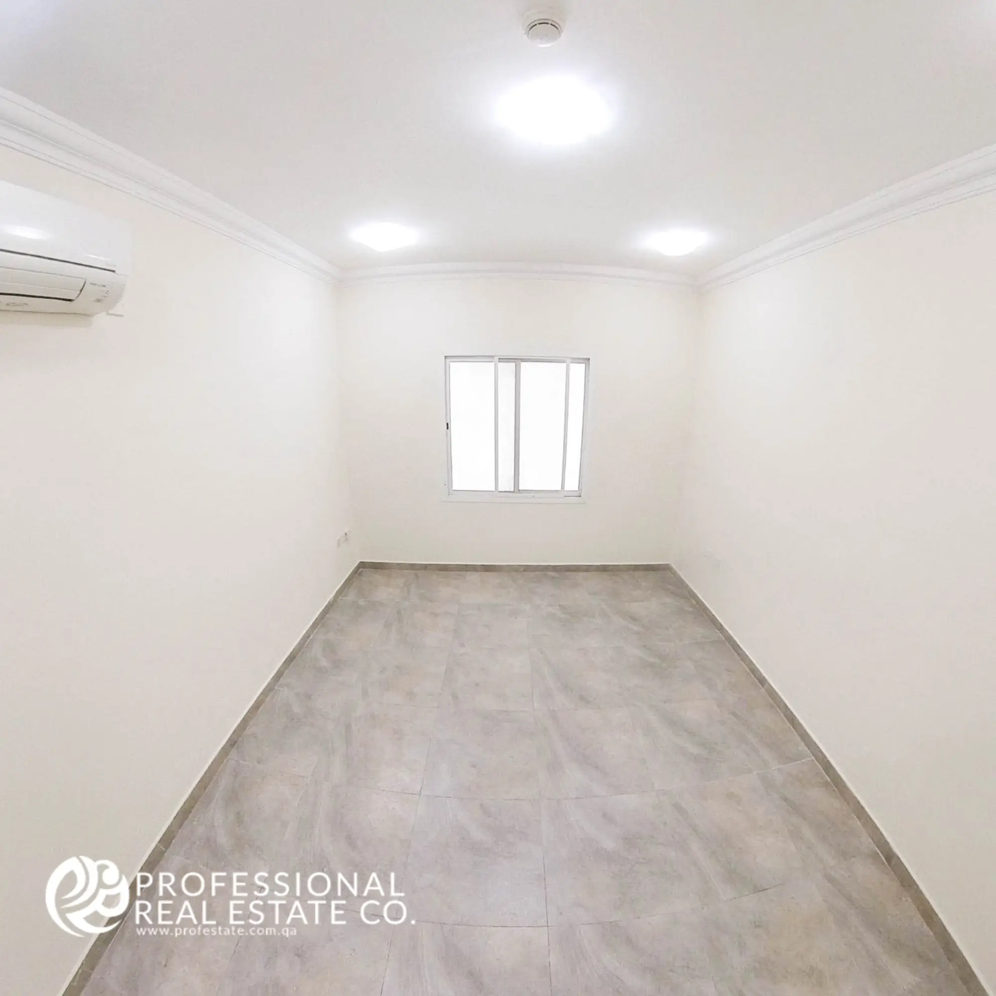 Living room opposite view facing window with natural light in an unfurnished 1 BHK apartment in Muntazah, Doha