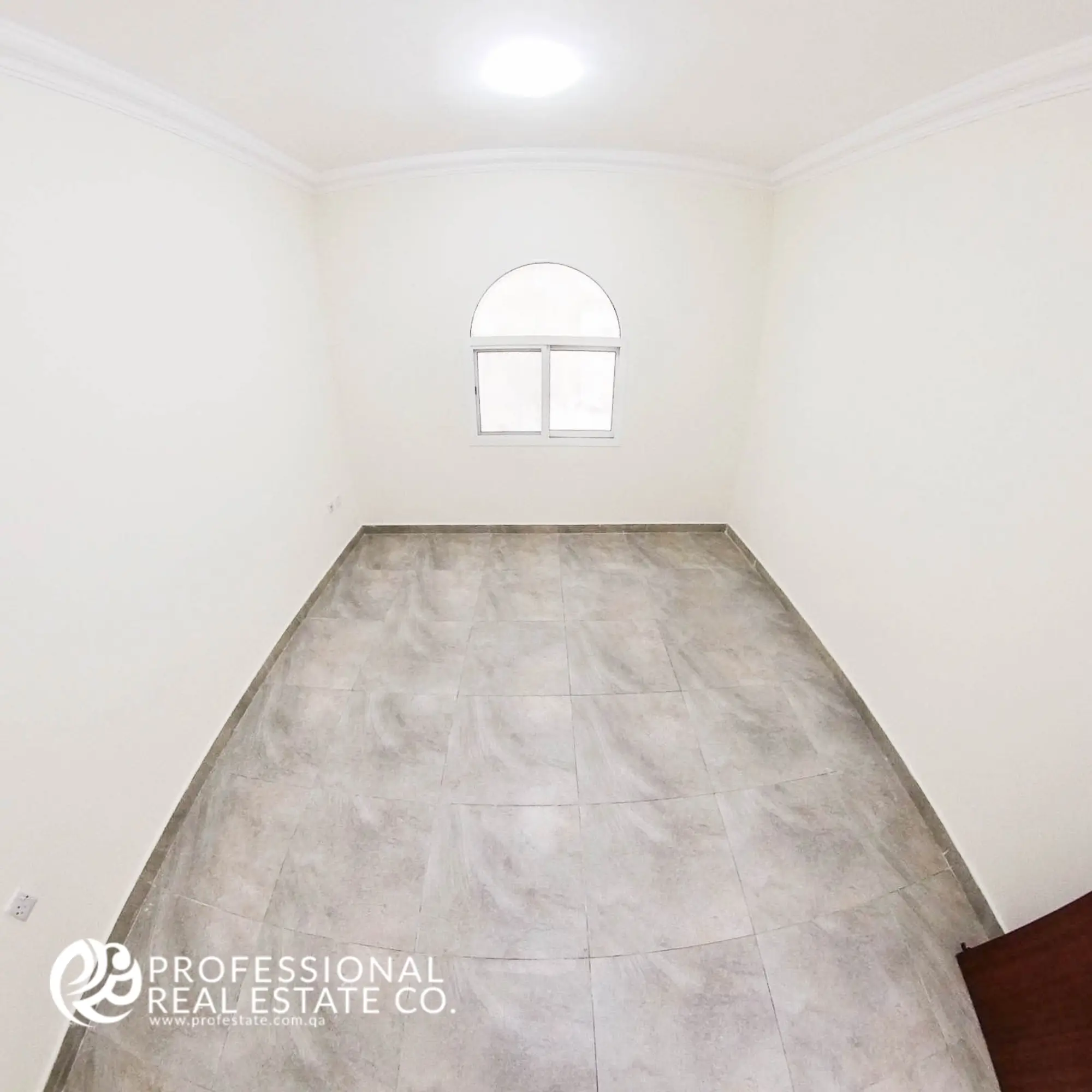 Bedroom with tiled flooring and neutral walls in an unfurnished 1 BHK apartment in Muntazah, Doha