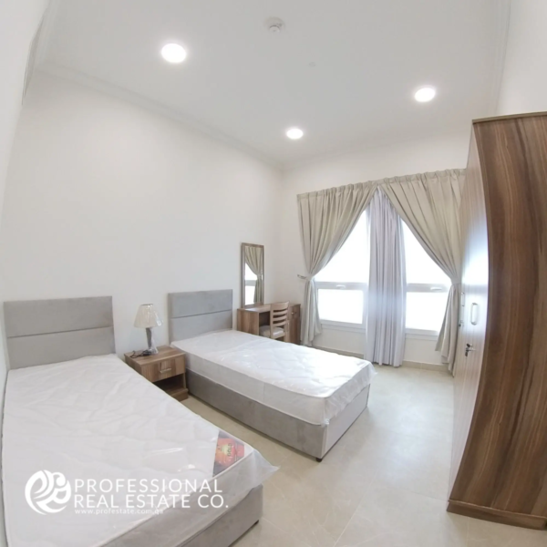 Alternative view of Bedroom 2 with two single beds and large window in a fully furnished 2 BHK apartment in Al Waab, Doha