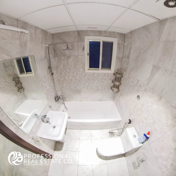 Toilet with bathtub and shower in an unfurnished 1 BHK apartment in Muntazah, Doha