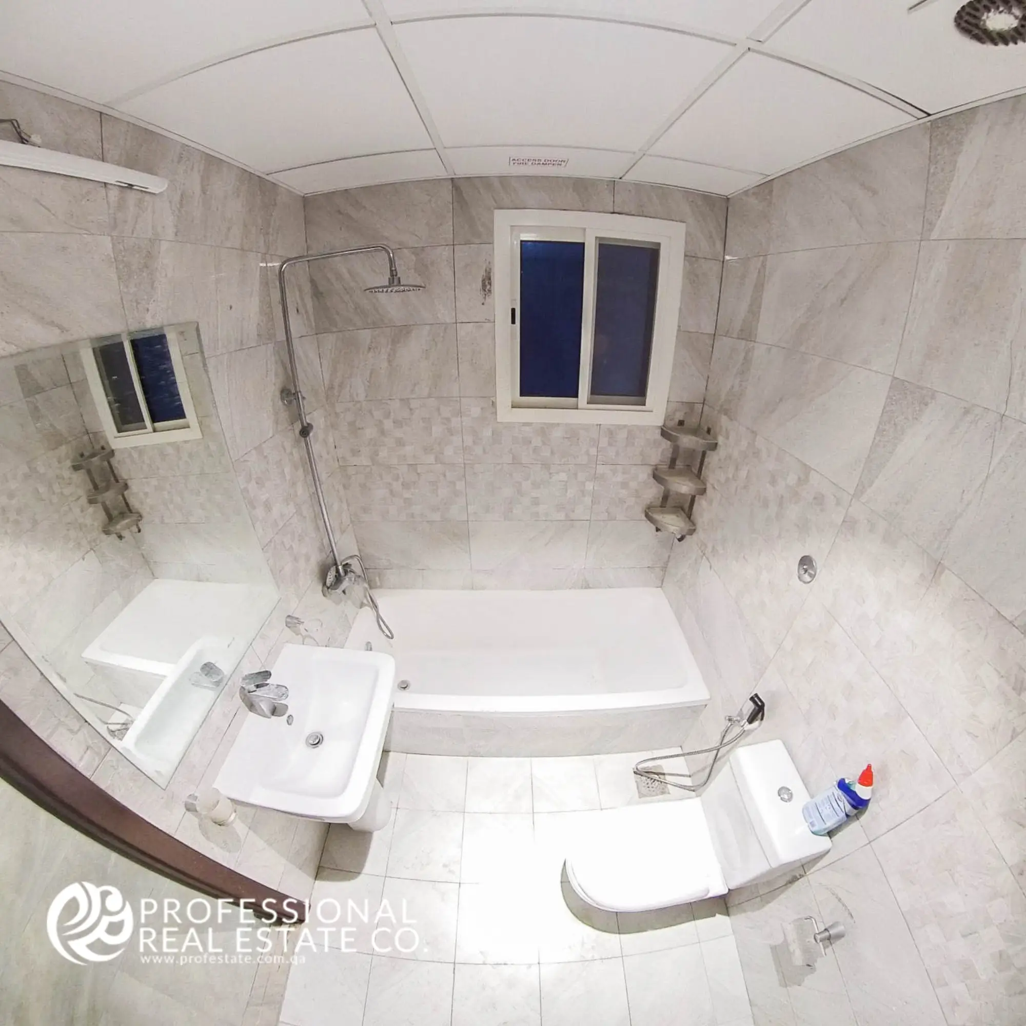 Toilet with bathtub and shower in an unfurnished 1 BHK apartment in Muntazah, Doha