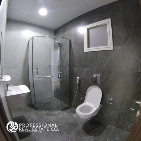 Toilet room with shower compartment in a fully furnished 2 BHK apartment in Al Waab, Doha